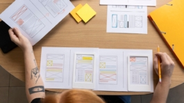 female-web-designer-taking-notes-office_23-2149749859