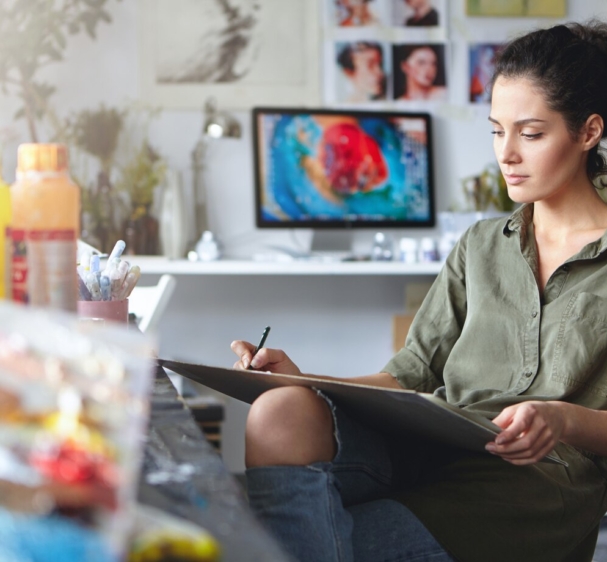 portrait-busy-confident-young-brunette-woman-designer-ripped-jeans-working-new-art-project-making-drawings-sketches-tablet-beautiful-female-artist-absorbed-with-her-creative-work_273609-341